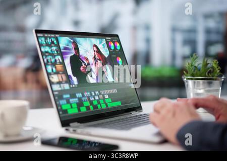 Young Graphic Designer Edits Video Using Advanced Editing Software On Laptop. Stock Photo