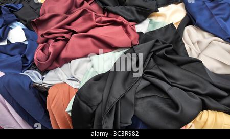 Brightly colored fabrics displayed at a market stall Stock Photo