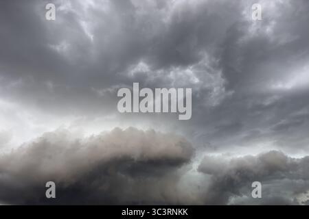 Below dark discoloured storm clouds Cloud roll above grey clouds Rain clouds heralding thunderstorms, Germany Stock Photo