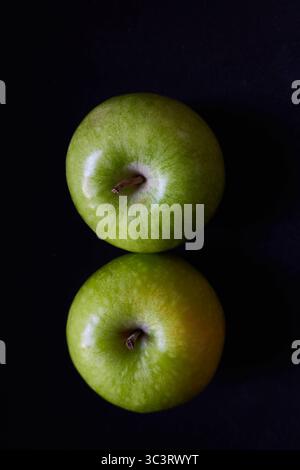 Two Green Apples from Above on a Black Background with Reflection Stock Photo