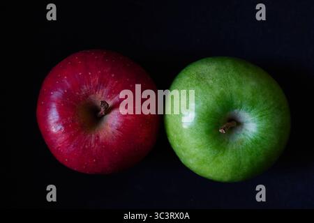 Red and Green Apples on a Dark Background in Close-Up View Stock Photo