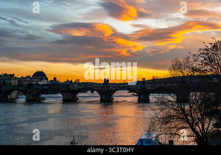 Colourful sunset over Charles Bridge (Karlův most) and the Vltava River in central Prague, capital and largest city of the Czech Republic Stock Photo