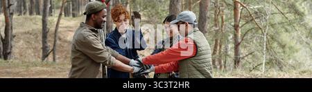 Diverse Young Adults Collaborating Outdoors during Team Building Activity Stock Photo