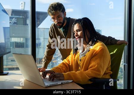 Business colleagues working together on laptop in office. Stock Photo