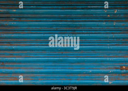Blue corrugated metal rolling shutter door texture. Stock Photo