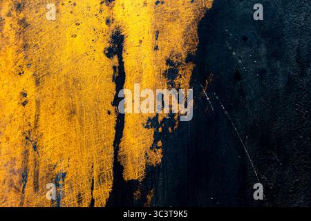 Heavily rusted yellow metal surface with peeling paint. Stock Photo