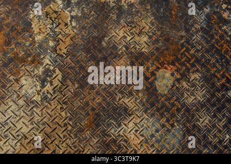 A detailed view of grungy rusty diamond plate metal surface. Highlights intricate details and fine textures. High-resolution 4K image. Stock Photo