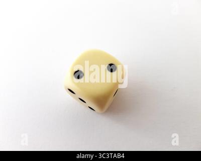 A vintage dice isolated on a white background. Stock Photo