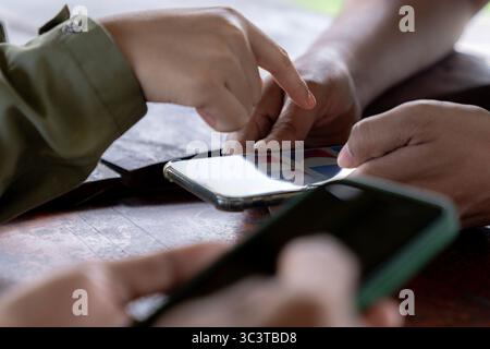A group of people using smartphones, showcasing modern communication and technology in everyday life. Stock Photo