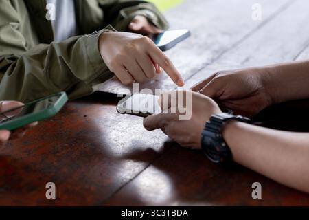 A group of people using smartphones, showcasing modern communication and technology in everyday life. Stock Photo