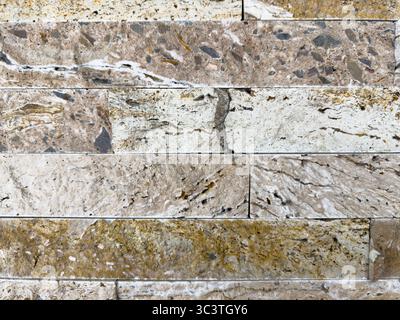 Stacked stone brick wall. Stone cladding wall made of striped stacked slabs of natural grey rocks. Panels for exterior. pattern of decorative slate st Stock Photo