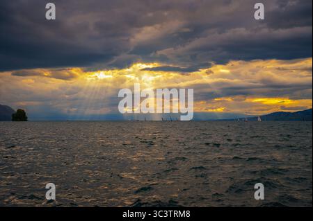 Sailboats Under Sunset Sky on Lake Geneva, Switzerland Stock Photo