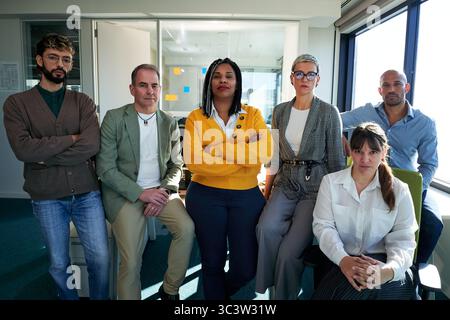 Startup business team posing together in modern office: collaboration and success. Stock Photo