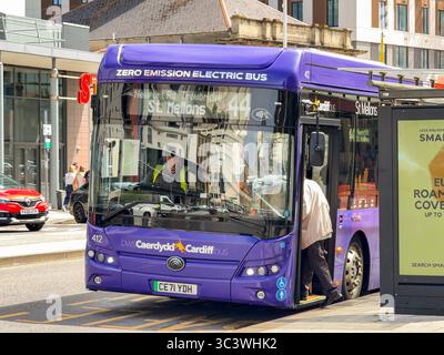 Cardiff, wales, UK - 16 July 2025: Passengers boarding an electric public service bus in Cardiff city centre. The service is operated by Cardiff Bus. Stock Photo