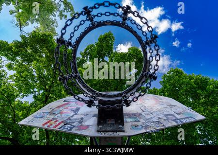 Urban basketball hoop covered in stickers at Helmholtzplatz, Berlin, seen from below on a sunny summer day Stock Photo