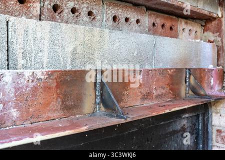Close up of an existing structural steel lintel being reinforced, repaired prior to bricks being reinstalled. Stock Photo