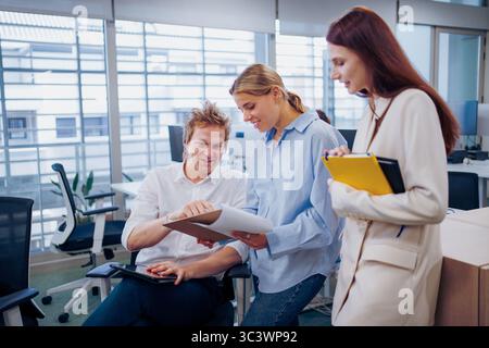 Collaborative Office Meeting with Industry Professionals Engaging in Project Discussion and Analysis Stock Photo