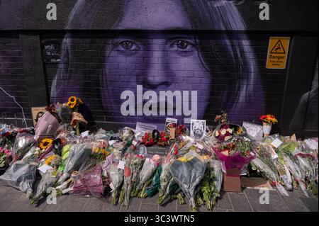 Ozzy Osbourne - Black Sabbath Mural - Navigation Street, Birmingham, with flowers and other gifts of respect following the death of Ozzy. Stock Photo