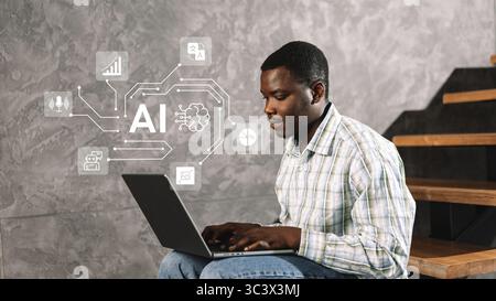 Young man engages with artificial intelligence technology while sitting on stairs in a modern interior during the day Stock Photo