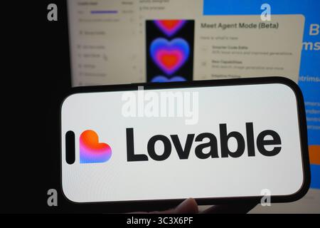 Roosendaal, The Netherlands – July 14, 2025: A smartphone showing the Lovable logo with its web platform for app building in the background. Stock Photo