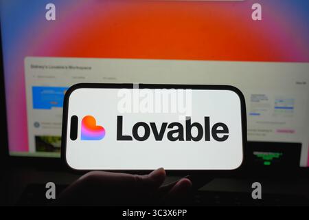 Roosendaal, The Netherlands – July 14, 2025: A smartphone showing the Lovable logo with its web platform for app building in the background. Stock Photo