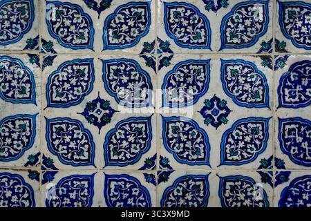Ornate blue and red handmade Turkish Iznik mosaic tiles with floral Islamic patterns in a traditional Ottoman style in Istanbul, Turkey Stock Photo