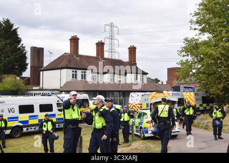 Epping, UK. 27th July, 2025. Police officers guard the Bell Hotel in Epping as both pro- and anti- migrant protesters gather outside. Several anti-migrant protests targeting the Bell Hotel, where migrants are housed, have taken place after an asylum seeker was charged with allegedly trying to kiss a 14-year-old girl. Credit: SOPA Images Limited/Alamy Live News Stock Photo