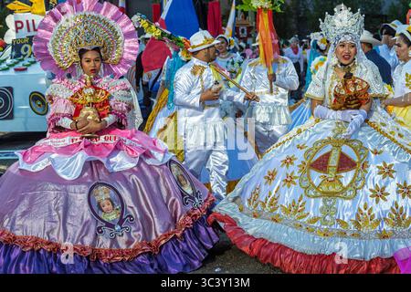 Colorful traditional dresses with intricate designs and floral decorations at the Calgary Stampede Parade. The Fiesta Filipino entry. Stock Photo