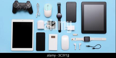 Many different modern gadgets on light blue background Stock Photo