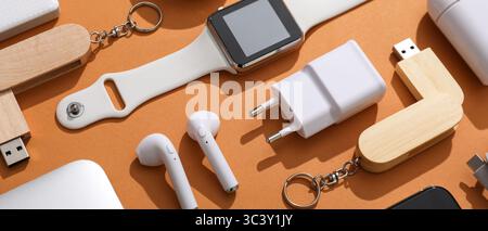 Many different modern gadgets on orange background Stock Photo