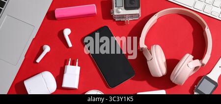 Many different modern gadgets on red background Stock Photo