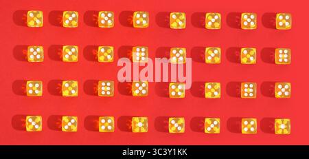 Yellow dices on red background. Pattern for design Stock Photo