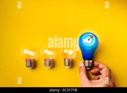 Happy new year 2026 banner. Creative idea with business goal, innovation concept. 2026 year numbers with target icon on blue bulb and clear light bulb Stock Photo