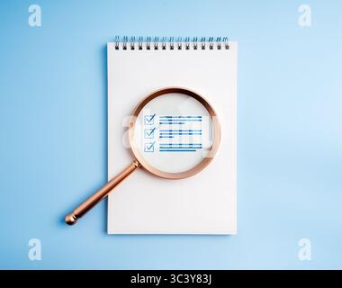 Document checklist, certificate management, Audit and quality control concept. Checklist document icon, reviewed in magnifying glass lens, on white ve Stock Photo