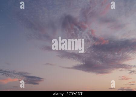 Radiant Sunset Sky with Swirling Cloud Formations Stock Photo