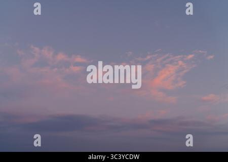 Minimalist Sky at Twilight with Faint Pink Cloud Streaks Stock Photo