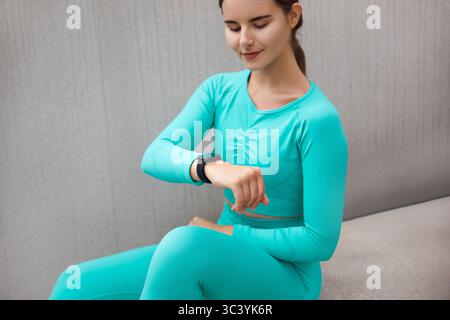 Woman Checking Heart Rate Using Smartwatch After Workout. Fit Female Monitoring Pulse On Smart Watch. Stock Photo