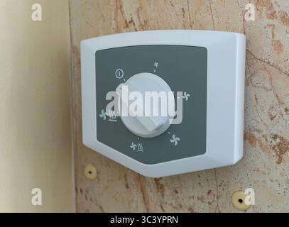 The ventilation intensity control panel of the climate control system mounted on the wall. Stock Photo