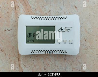 Climate control system control panel mounted on the wall in the off state. Stock Photo