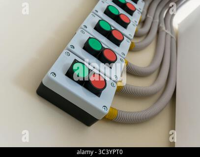 Control panel with 'Start' and 'Stop' buttons mounted on the wall. Stock Photo