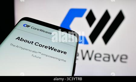 Stuttgart, Germany - 06-07-2025: Mobile phone with website of US AI cloud computing company CoreWeave Inc. on screen in front of logo. Stock Photo