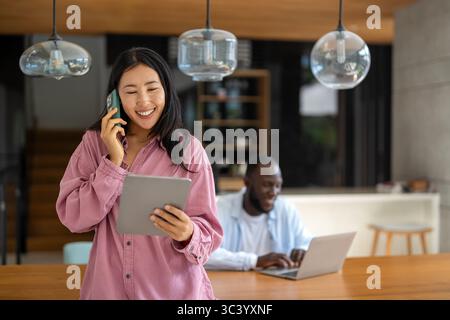 Couple of freelance IT specialists using digital technology devices while working remotely from home Stock Photo