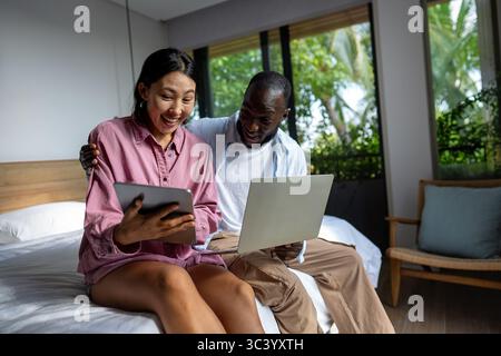 Online entertainment and social media. Diverse, multiethnic couple enjoying the digital world Stock Photo