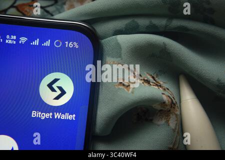 Dhaka, Bangladesh- 07 May 2025: Bitget wallet app icon is seen on smartphone Stock Photo