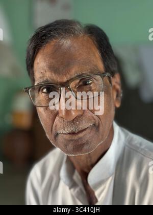 Portrait of an elderly man with glasses and a pensive expression in an interior, Alamgir Mosque, Varanasi, Uttar Pradesh, India Stock Photo