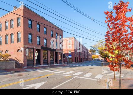 Traditional American brick buildings converted into loft apartments and commercial spaces along a street on a clear autumn day Stock Photo