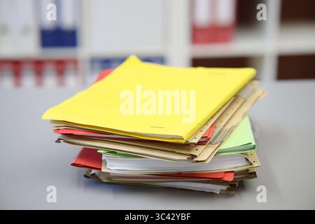Different colored files lying on a desk, yellow Stock Photo