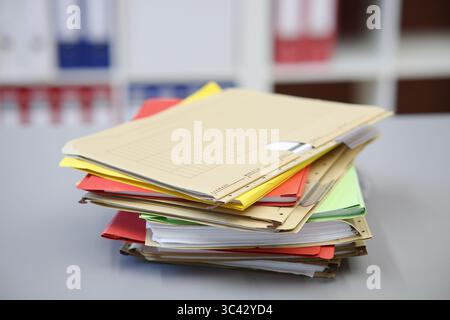 Different colored files lying on a desk, brown Stock Photo