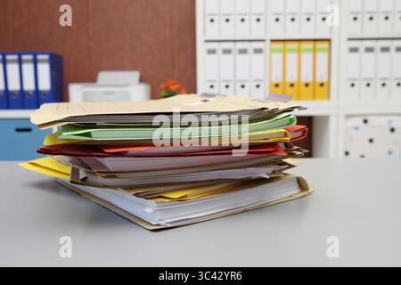 Different colored files lying on a desk, side view Stock Photo