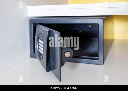 Open empty safe in a hotel room or home. Close-up of the mechanism of a small safe. Focus on the lock. High quality photo Stock Photo